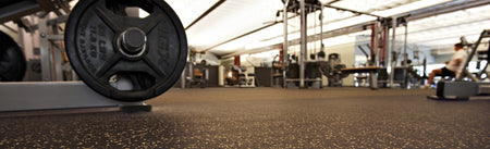 REGUPOL aktiv rolled rubber flooring installed in a commercial gym weight area