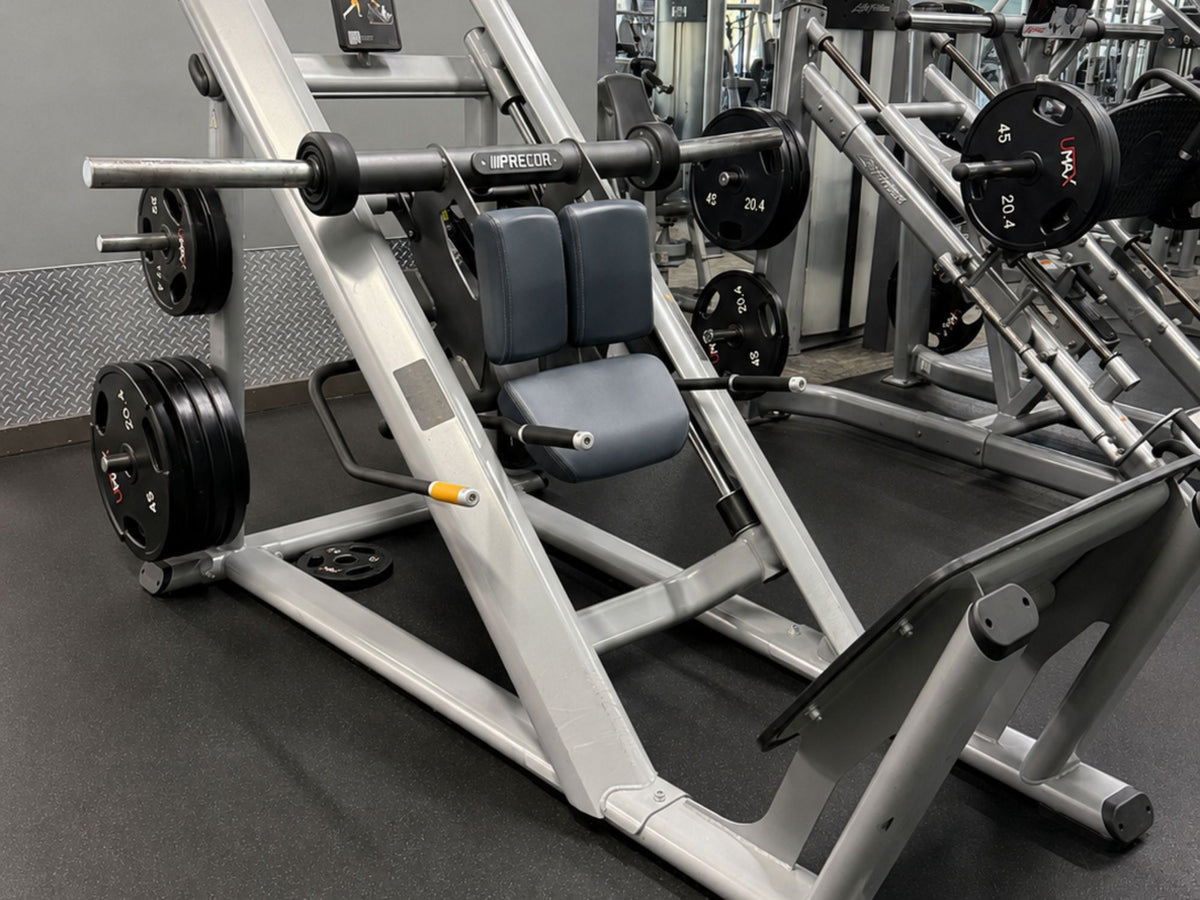 Precor plate-loaded leg press included in a premium pre-owned commercial gym equipment package.