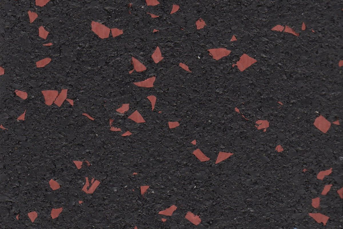 Firestorm Red REGUPOL rubber gym flooring material photo showing red flecks on a black base