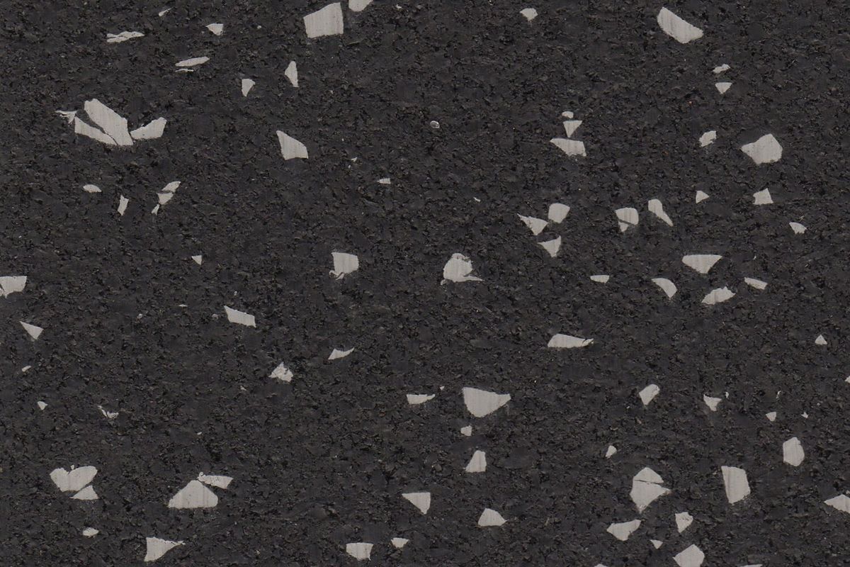 Gray Hound REGUPOL rubber gym flooring material photo showing gray flecks on a black base