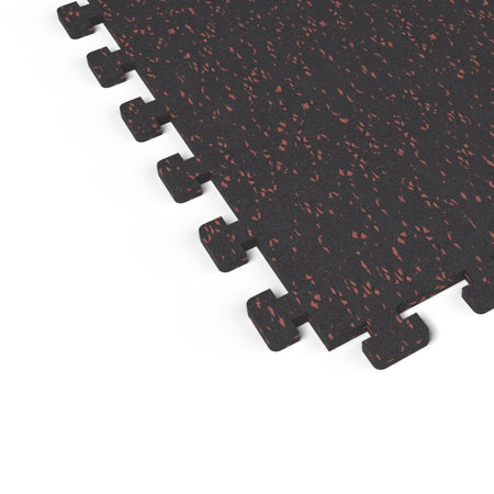 Close-up of the puzzle-edge interlock on a Firestorm Red REGUPOL aktivlok rubber gym tile showing red flecks on a black base
