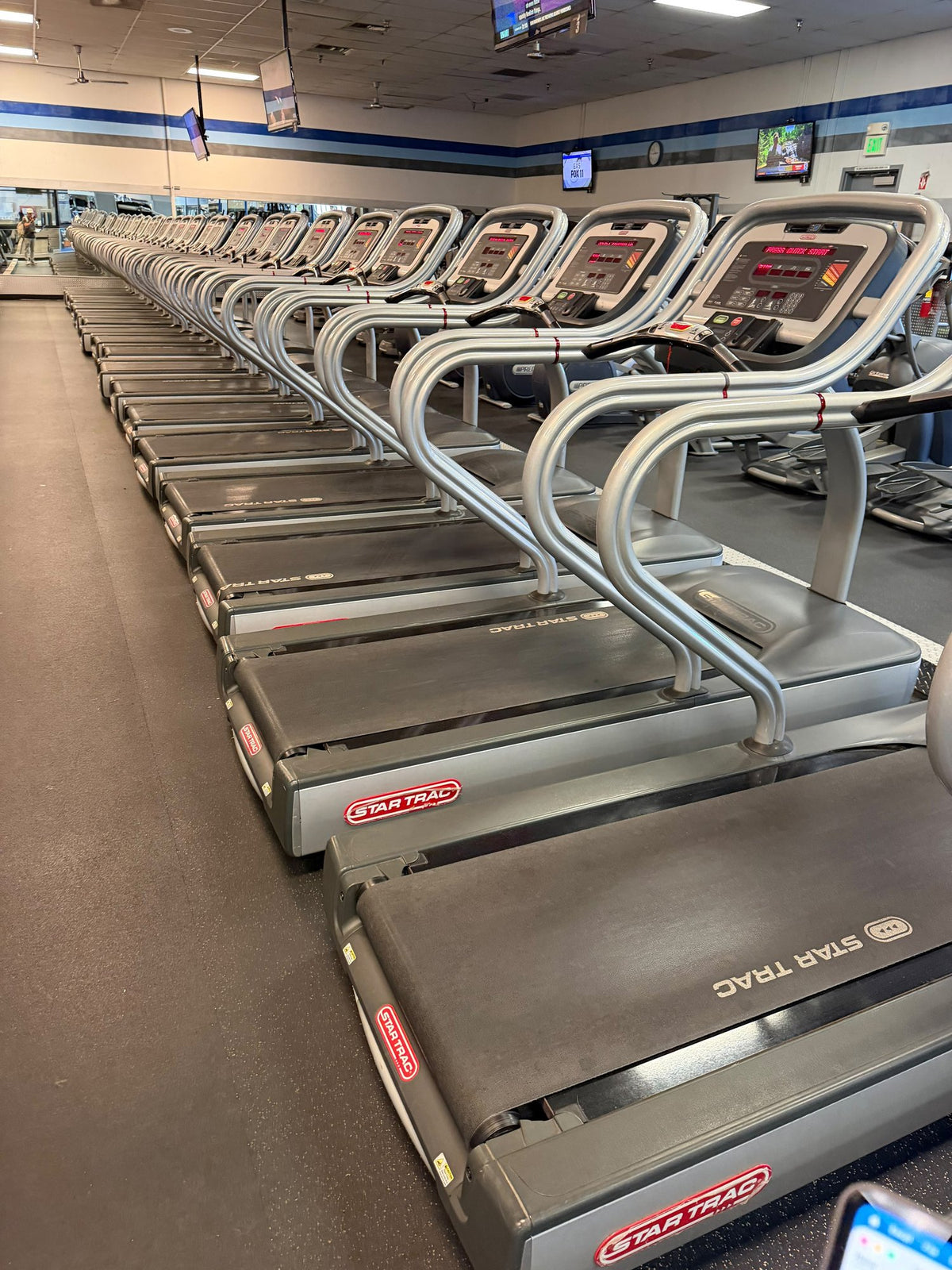 Row of Star Trac E-TRx commercial treadmills – used commercial gym equipment package