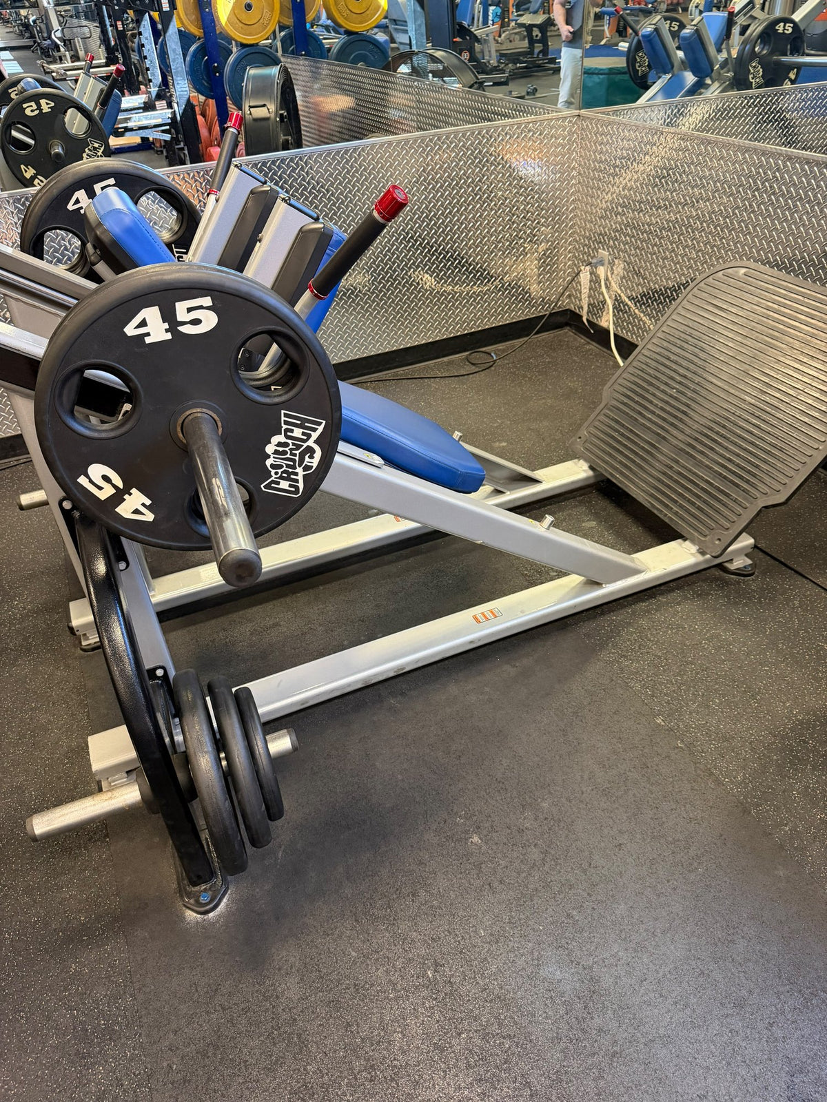 Star Trac plate-loaded hack squat with 45 lb plates – used commercial gym equipment package